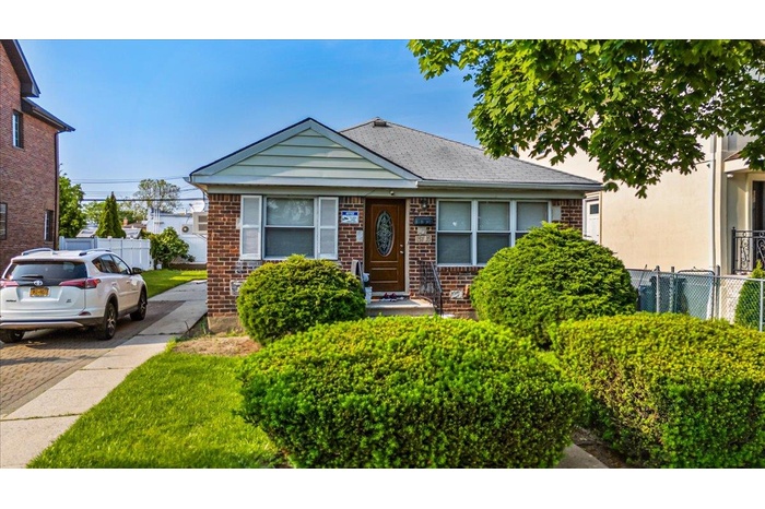 Bungalow-style house with brick siding and driveway