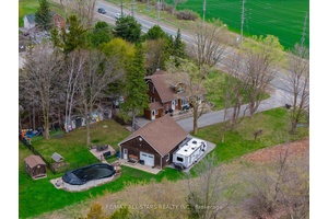 Rural Serenity Meets Urban Convenience in this 4 Bedroom Home with Workshop on an Expansive Lot !