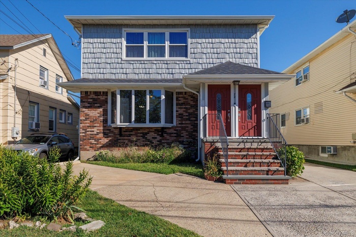 View of front facade featuring brick siding