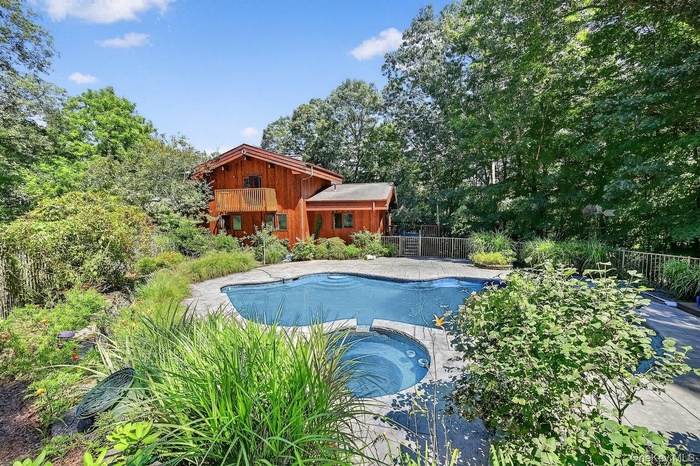 View of pool with a pool with connected hot tub and a patio area