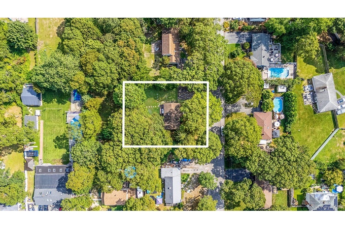 Aerial view of property and surrounding area with property parcel outlined