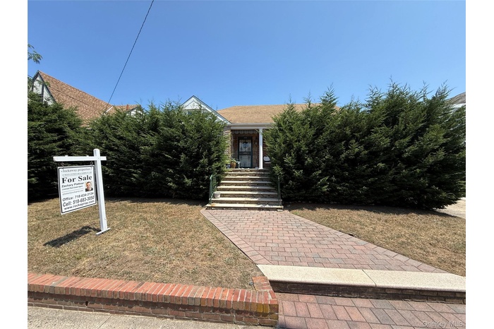 Obstructed view of property featuring roof with shingles