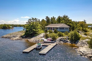 Carved from granite and framed by windswept pines, this stunning island in Georgian Bay's prized Cognashene area offers 520 feet of pristine shoreline and 1.