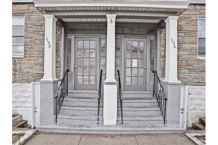 Property entrance featuring stone siding