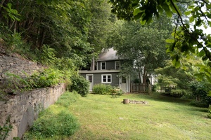 Stone Walls is an updated classic, nestled into a flat lot lined by striking old bluestone walls and lush landscape.