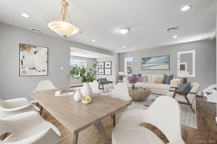 Dining room with wood finished floors and recessed lighting