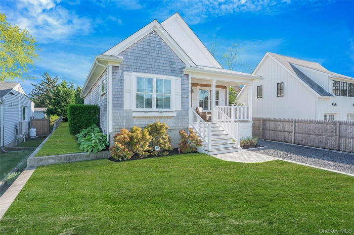 View of front of property featuring covered porch and stairway