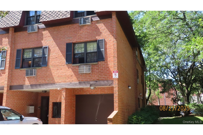 View of property exterior featuring brick siding and an attached garage