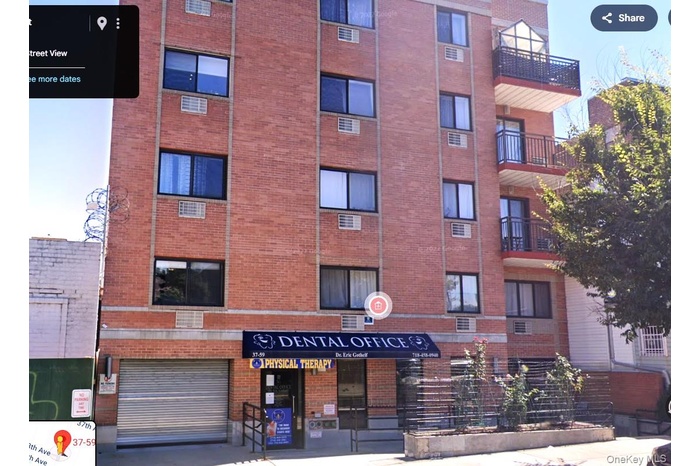 View of apartment building / complex featuring a garage