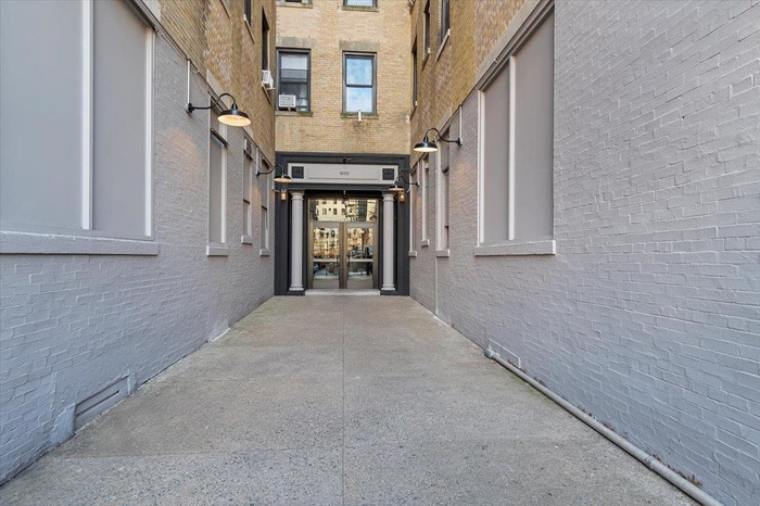 Entrance to property featuring brick siding