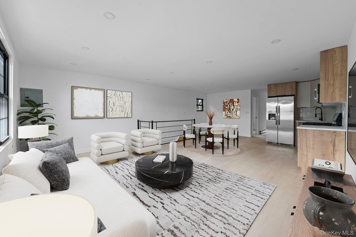 Living room with light wood-type flooring, recessed lighting, and electric panel