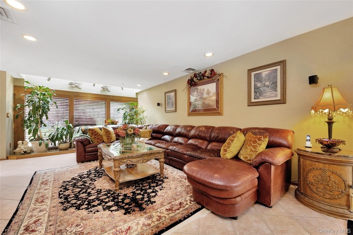 Living area featuring light tile patterned flooring and recessed lighting