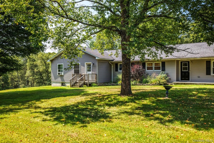 Ranch-style home featuring a front yard and a shingled roof