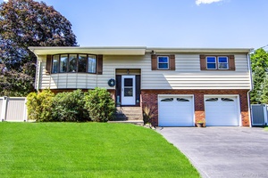 Beautifully maintained high ranch with expansive backyard retreat !