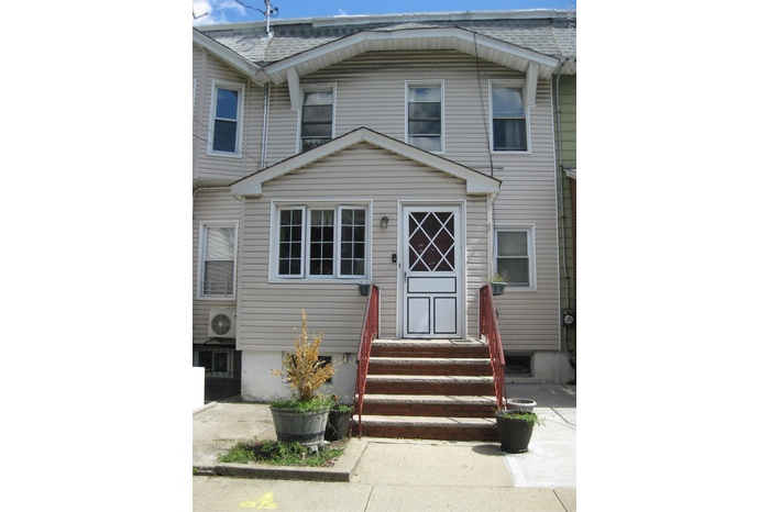 View of front of home featuring roof with shingles