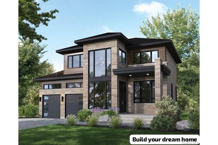 View of front of house with stone siding, driveway, and a front yard