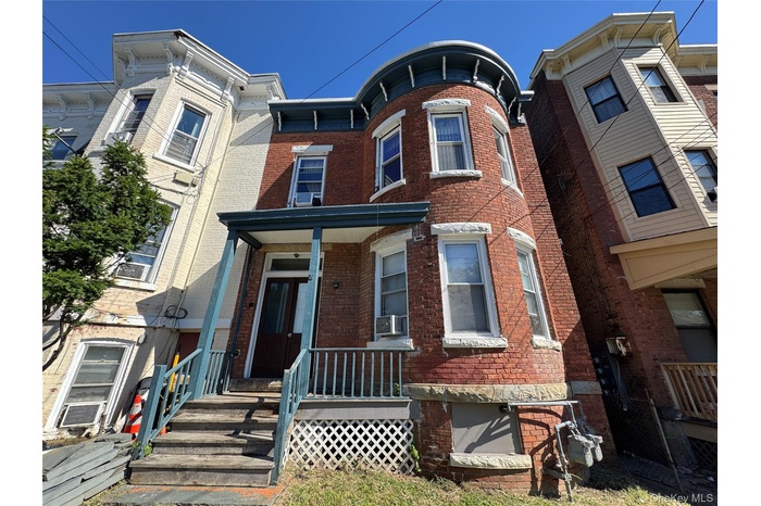Italianate home with brick siding and covered porch