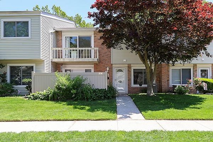 View of property with brick siding