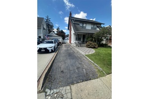 Nestled in Lynbrook, this inviting residence sits on a spacious 40x125 foot lot with a 2 car garage and a semi above ground pool.