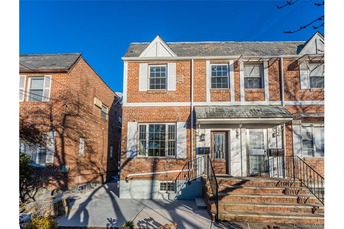 Traditional home with brick siding and a high end roof