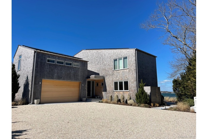 Modern home featuring gravel driveway