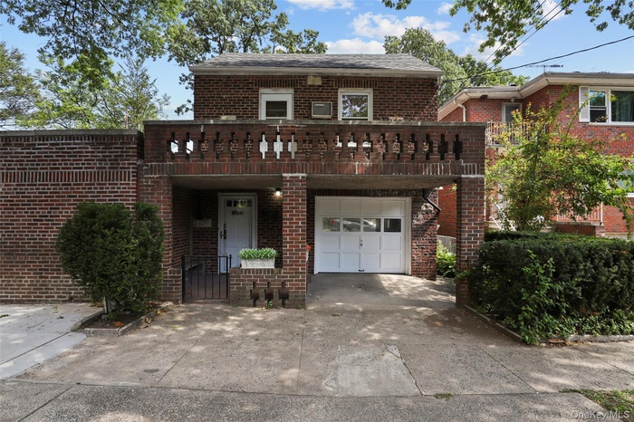 View of front of home featuring brick siding, concrete driveway, and an attached garage