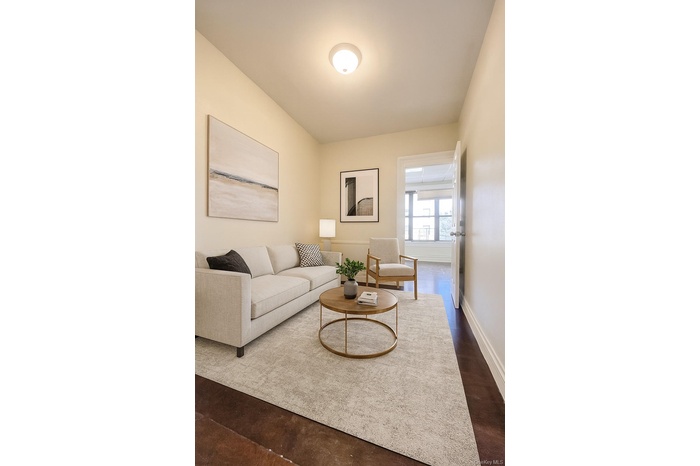 Living room with dark wood-style flooring and baseboards
