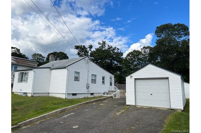 Detached garage with asphalt driveway