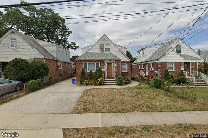 Bungalow-style home with brick siding and concrete driveway