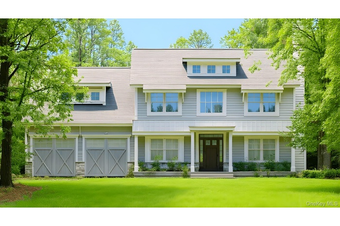 View of front facade featuring a front yard and a garage
