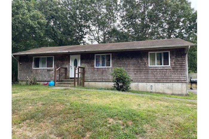Single story home with a front lawn