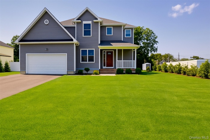 View of front of house featuring a porch, asphalt driveway, and roof with shingles