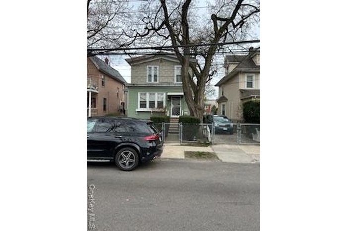 Traditional style home featuring a gate and fence