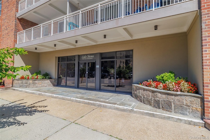 Property entrance with stucco siding and brick siding