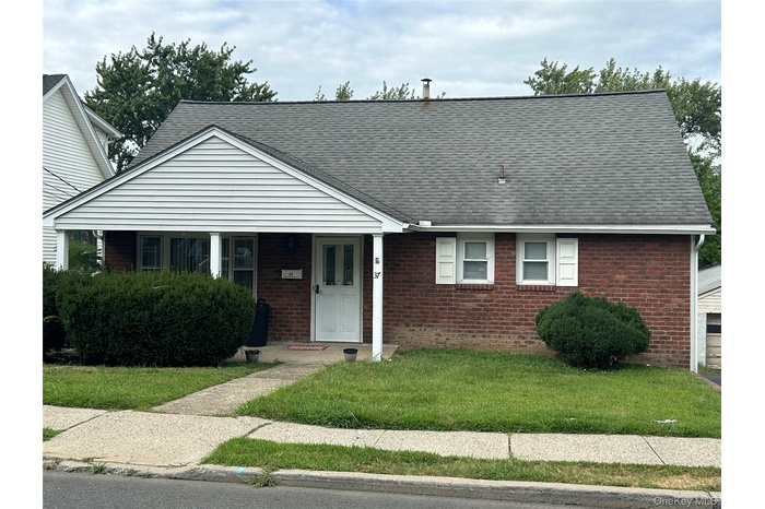 View of front of home featuring a porch, a front yard, and roof with shingles