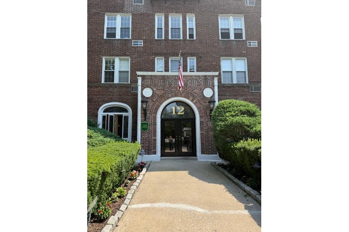 View of exterior entry with brick siding and french doors