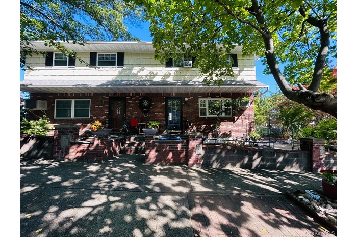 View of front of house featuring brick siding and covered porch