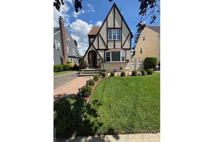 Tudor home featuring stucco siding