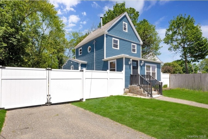View of front of property featuring a gate