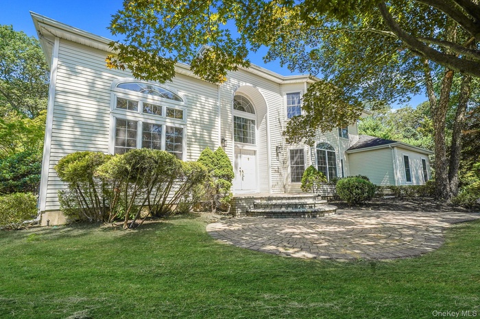 View of front of home with a front lawn and a patio area