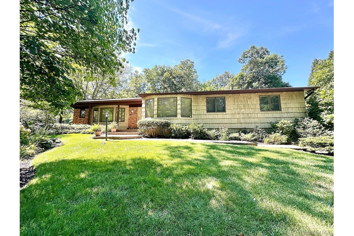 Ranch-style house with a front lawn and a porch
