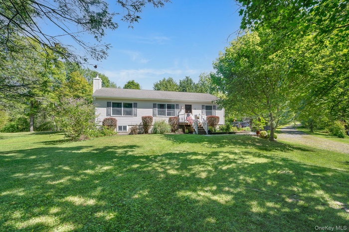 Single story home featuring a front yard and a chimney
