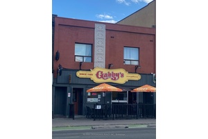 Two store frontages turned into one, with two one bedroom apts.