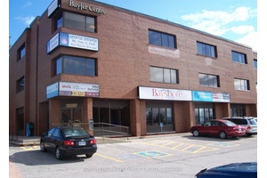 Nestled near the corner of one of Barrie's bustling streets, a three story professional office building offers a large suite for businesses.