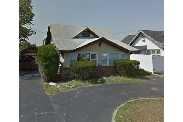 Bungalow-style house featuring brick siding and stucco siding