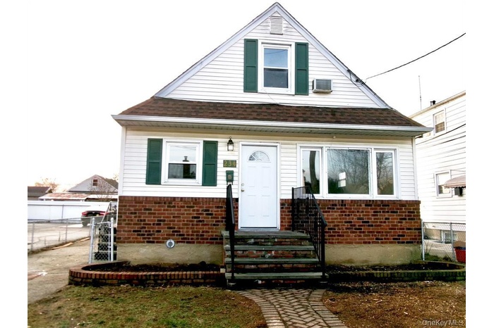 Bungalow-style house with brick siding