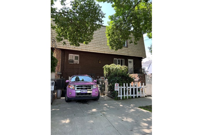 Multi unit property featuring mansard roof and brick siding