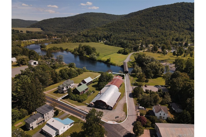 Aerial overview of property's location featuring a water and mountain view