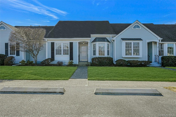 View of front of house with a front yard and roof with shingles