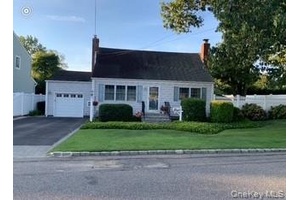 This charming 4 bedroom Cape style home exudes warmth and timeless elegance, nestled on a beautifully landscaped property that feels like a serene park.